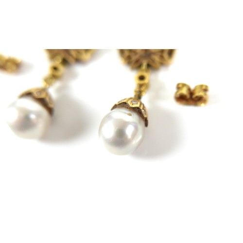 373 - A pair of 18ct gold and pearl drop earrings, early to mid 20th century, formed of bow design studs s... 