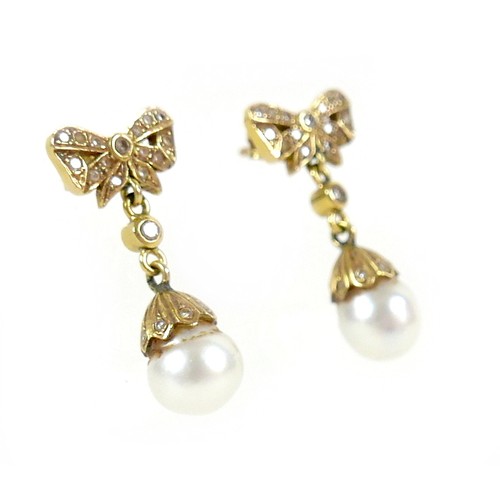 373 - A pair of 18ct gold and pearl drop earrings, early to mid 20th century, formed of bow design studs s... 