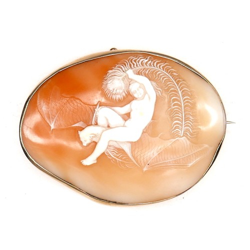 295 - A Victorian gold oval shaped cameo brooch, finely carved with a nude riding a large bat and holding ... 