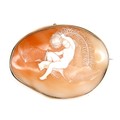A Victorian gold oval shaped cameo brooch, finely carved with 'Ariel riding a Bat', depicting a nude... 