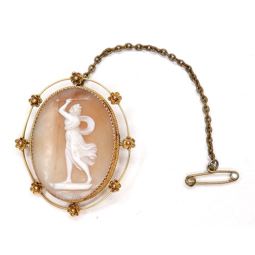 248 - A Victorian 9ct gold oval shaped cameo brooch, carved with a classical lady brandishing an arrow abo... 