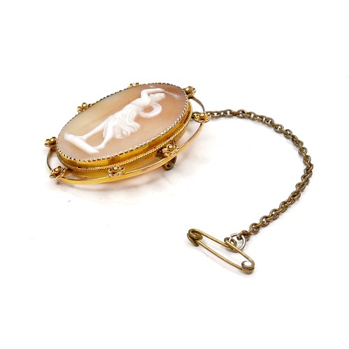 248 - A Victorian 9ct gold oval shaped cameo brooch, carved with a classical lady brandishing an arrow abo... 