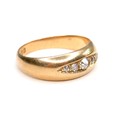 An 18ct gold and diamond five stone ring, formed of graduated old cut stones, largest 2.5mm, size L,... 