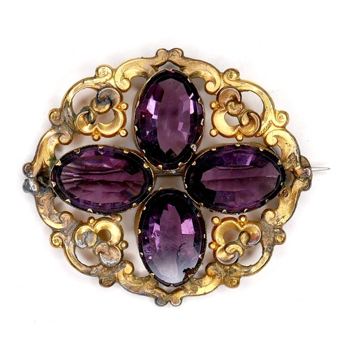 250 - A Victorian gilt brass brooch set with amethysts, the four oval stones each 18 by 12 by 6mm, and of ... 