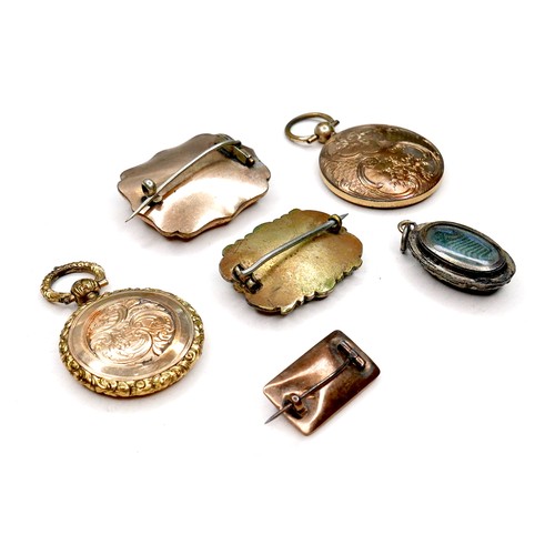 360 - A group of gold and yellow metal memorial jewellery, comprising two round lockets, each inset with a... 