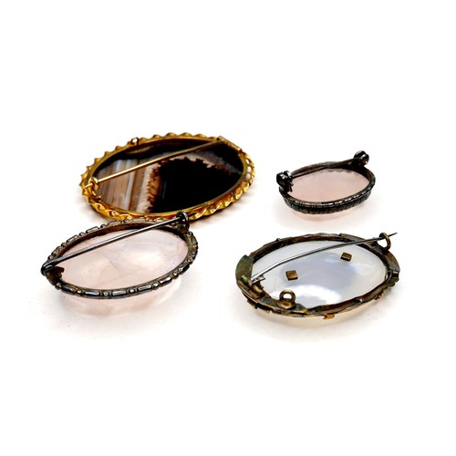 257 - A group of four 19th century brooches, comprising two Victorian brooches, one set with an oval black... 