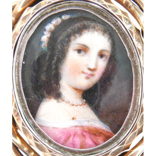 252 - An early 19th century gold framed portrait miniature brooch, depicting a girl in a pink dress, swive... 