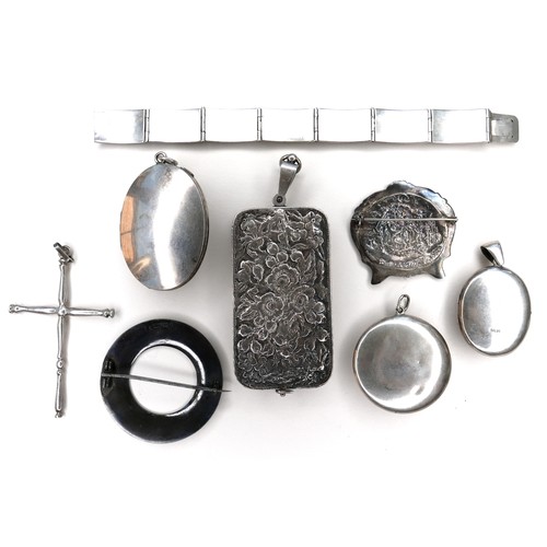 262 - A collection of silver brooches and pendants, including locket pendants, a cross pendant, and an Edw... 