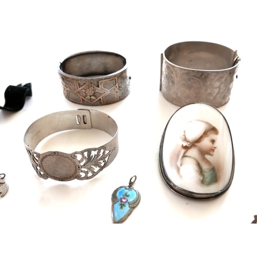 263 - A group of silver jewellery, including four wide hinged bangles, 208.2g combined, a portrait miniatu... 