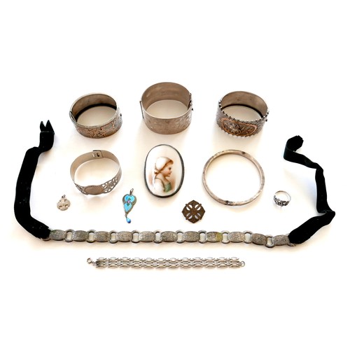 263 - A group of silver jewellery, including four wide hinged bangles, 208.2g combined, a portrait miniatu... 