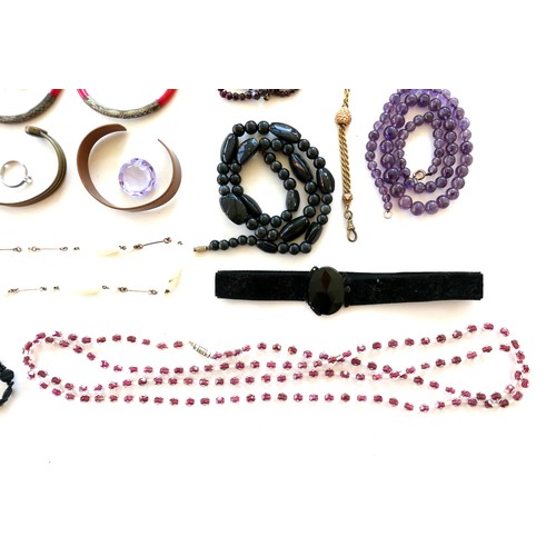 264 - A group of costume jewellery, including a string of pink hard stone beads, amethyst bead necklaces, ... 