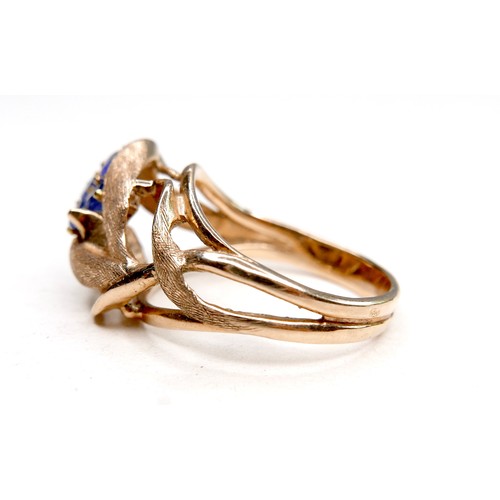 260 - A gold dress ring in the form of a flower, set with four small cornflower blue sapphires, marks rubb... 