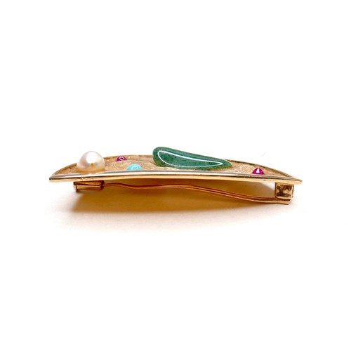 357 - An unmarked 18ct yellow gold brooch, of modernist triangular form, set randomly with jade, two rubie... 