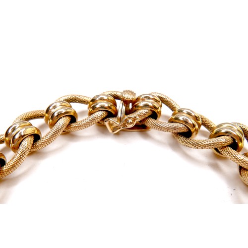 386 - An Italian 18ct gold bracelet, with fancy decorated links, press clasp and safety catch, stamped 750... 