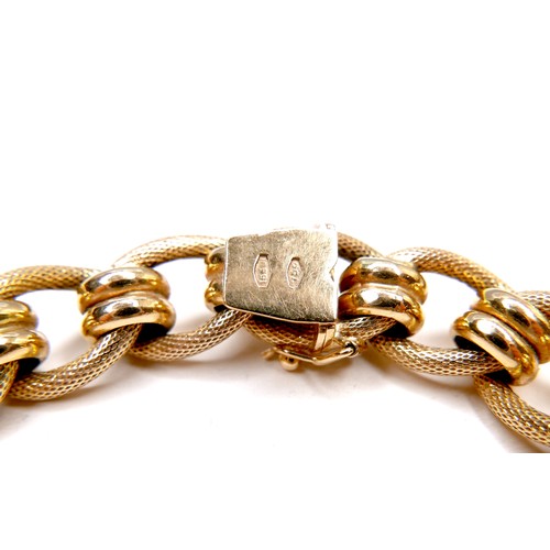 386 - An Italian 18ct gold bracelet, with fancy decorated links, press clasp and safety catch, stamped 750... 