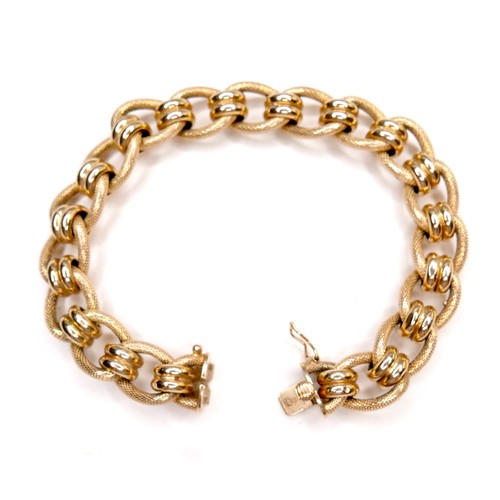 386 - An Italian 18ct gold bracelet, with fancy decorated links, press clasp and safety catch, stamped 750... 