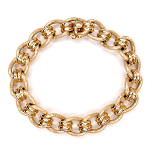 386 - An Italian 18ct gold bracelet, with fancy decorated links, press clasp and safety catch, stamped 750... 