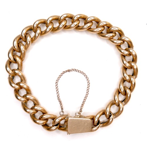 388 - A foreign 18ct yellow gold large curb link bracelet, press clasp and safety chain attached, tests as... 