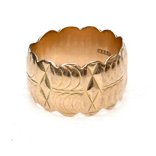 274 - A 9ct gold wide ring with scalloped edges and engraved design, size Q/R, 12mm wide, 7.4g.