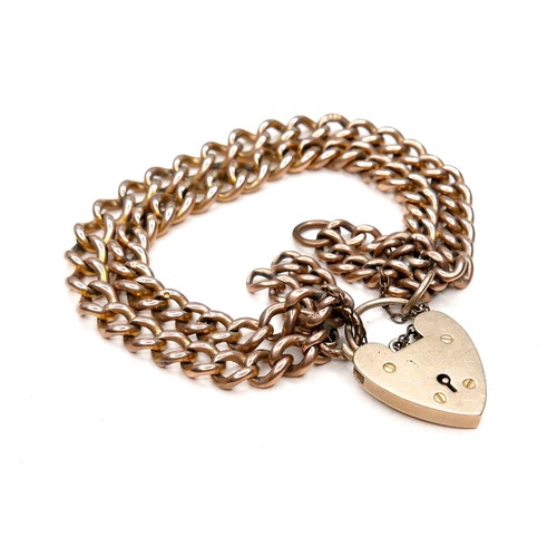 366 - A 9ct gold bracelet with heart padlock clasp, of double kerb link design, marked to each link and pa... 