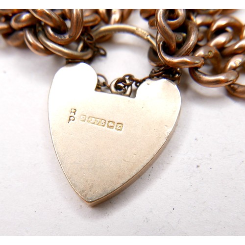 366 - A 9ct gold bracelet with heart padlock clasp, of double kerb link design, marked to each link and pa... 