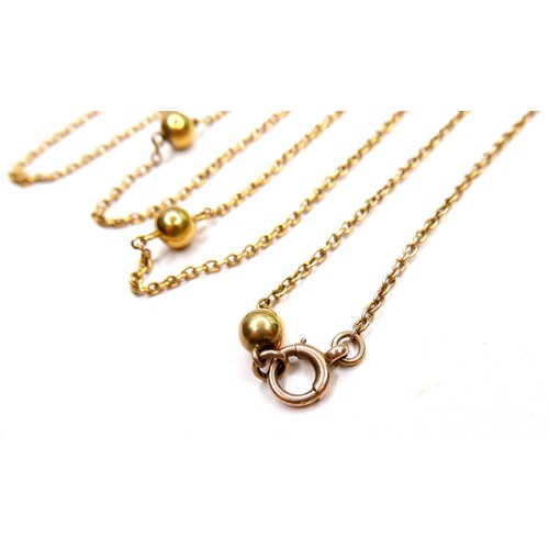 367 - An unmarked 18ct yellow gold guard chain necklace, formed of twelve spheres joined by lengths of cha... 