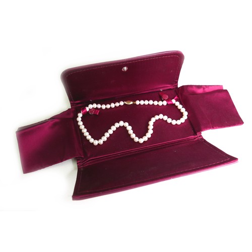 270 - A single strand pearl necklace with 14ct gold clasp, the evenly sized pearls each approximately 6mm ... 