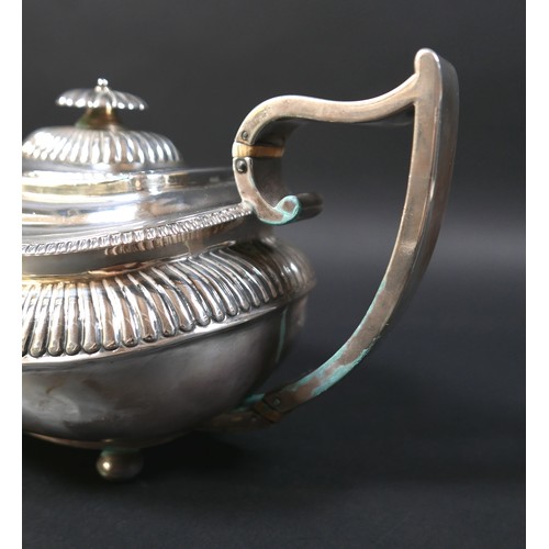 94 - A Regency silver teapot, of compressed urn form with gadrooned decoration, on bun feet, the handle w... 