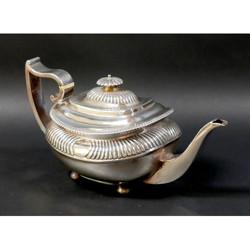 94 - A Regency silver teapot, of compressed urn form with gadrooned decoration, on bun feet, the handle w... 