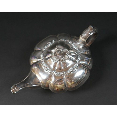 100 - A Regency silver teapot, of lobed melon form with pomegranate finial to the hinged cover, on a circu... 