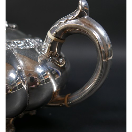 100 - A Regency silver teapot, of lobed melon form with pomegranate finial to the hinged cover, on a circu... 