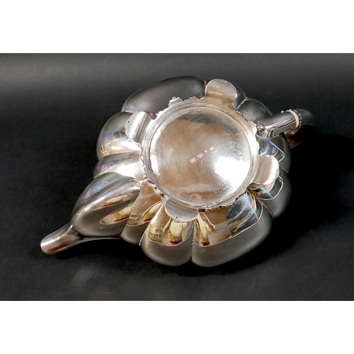 100 - A Regency silver teapot, of lobed melon form with pomegranate finial to the hinged cover, on a circu... 