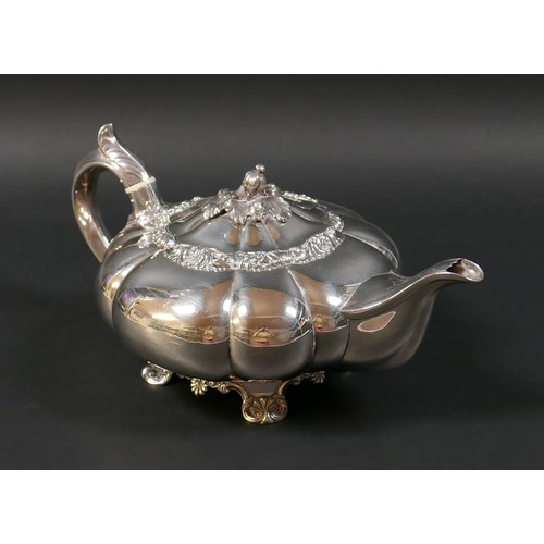 100 - A Regency silver teapot, of lobed melon form with pomegranate finial to the hinged cover, on a circu... 