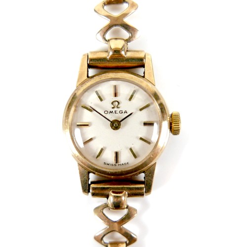 206A - An Omega 9ct gold lady's wristwatch, circa 1965, model 511.5182, with circular champagne dial, gold ... 