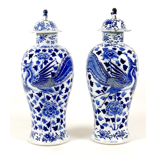 12 - A pair of Chinese porcelain vases, Qing Dynasty, 19th century, each of baluster form, the associated... 