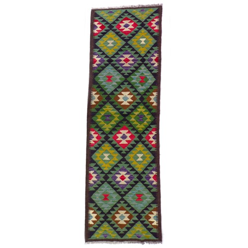 142 - A Maimana Kilim runner, with diamond patterned of brown, purple, red, and blue, encased in a brown b... 