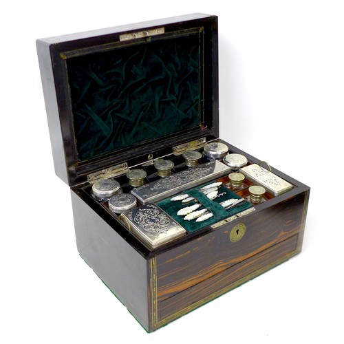 109 - A Victorian coromandel and brass inlaid vanity case, fitted with silver topped and pierced jars and ... 