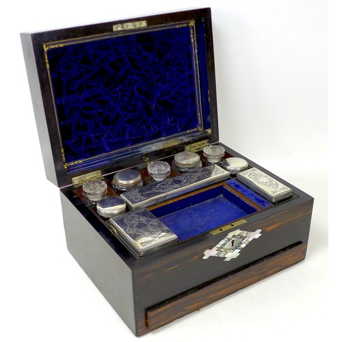 107 - A 19th century coromandel vanity case, with mother of pearl inlays, containing seven silver topped g... 