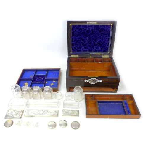 107 - A 19th century coromandel vanity case, with mother of pearl inlays, containing seven silver topped g... 