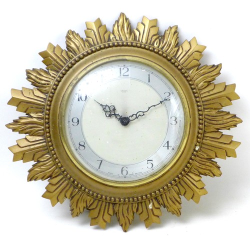 91 - A vintage Smiths Sectric sunburst form wall clock, 33 by 33 by 7 cm.