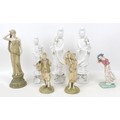 A group of ceramic figurines, a pair of Royal Worcester blush ivory, model 1206, modelled as a man a... 