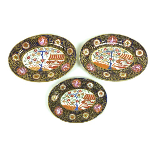 37 - A group of three oval serving dishes, early 19th century, decorated with reserves of a Chinese garde... 