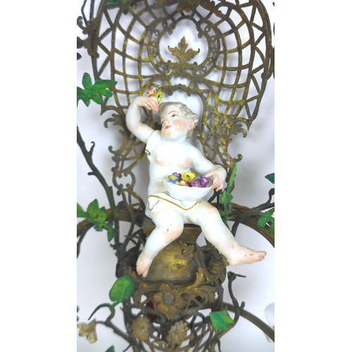 55 - A pair of Rococo style gilt metal, two branch wall lights, modelled with Dresden porcelain cherubs, ... 