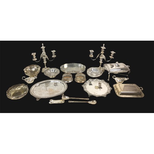 67 - A collection of silver plated wares, including a pair of candelabra, a lidded serving dish on stand,... 