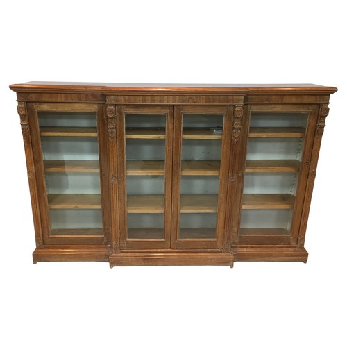 188 - An Edwardian mahogany breakfront bookcase, with plaster column mounts interspersed between four glaz... 