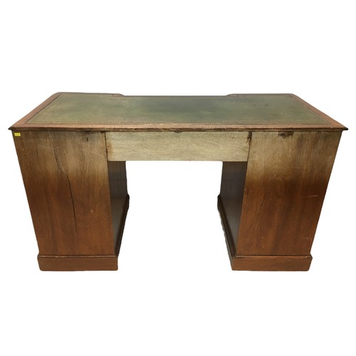 163 - An early 20th century mahogany inverted kneehole desk, with leather inset top, a single drawer flank... 