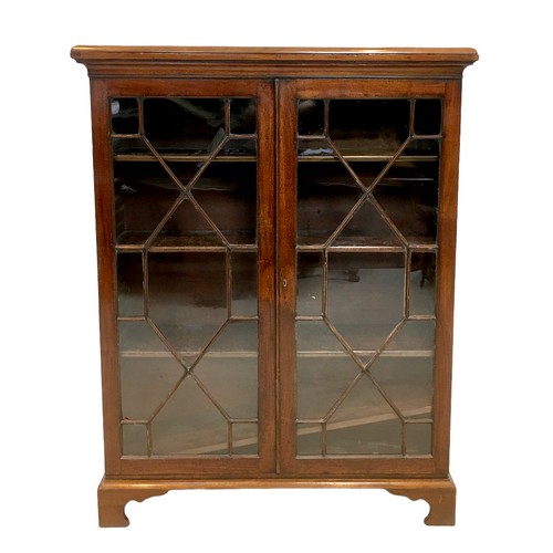 152 - An early 20th century mahogany bookcase, with four adjustable shelves enclosed by two glazed doors, ... 