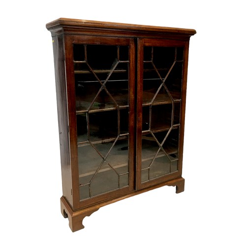 152 - An early 20th century mahogany bookcase, with four adjustable shelves enclosed by two glazed doors, ... 