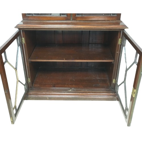 162 - An early 20th century mahogany bookcase, the top section with three shelves, the base section with a... 