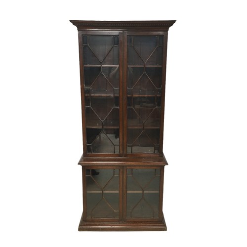 162 - An early 20th century mahogany bookcase, the top section with three shelves, the base section with a... 